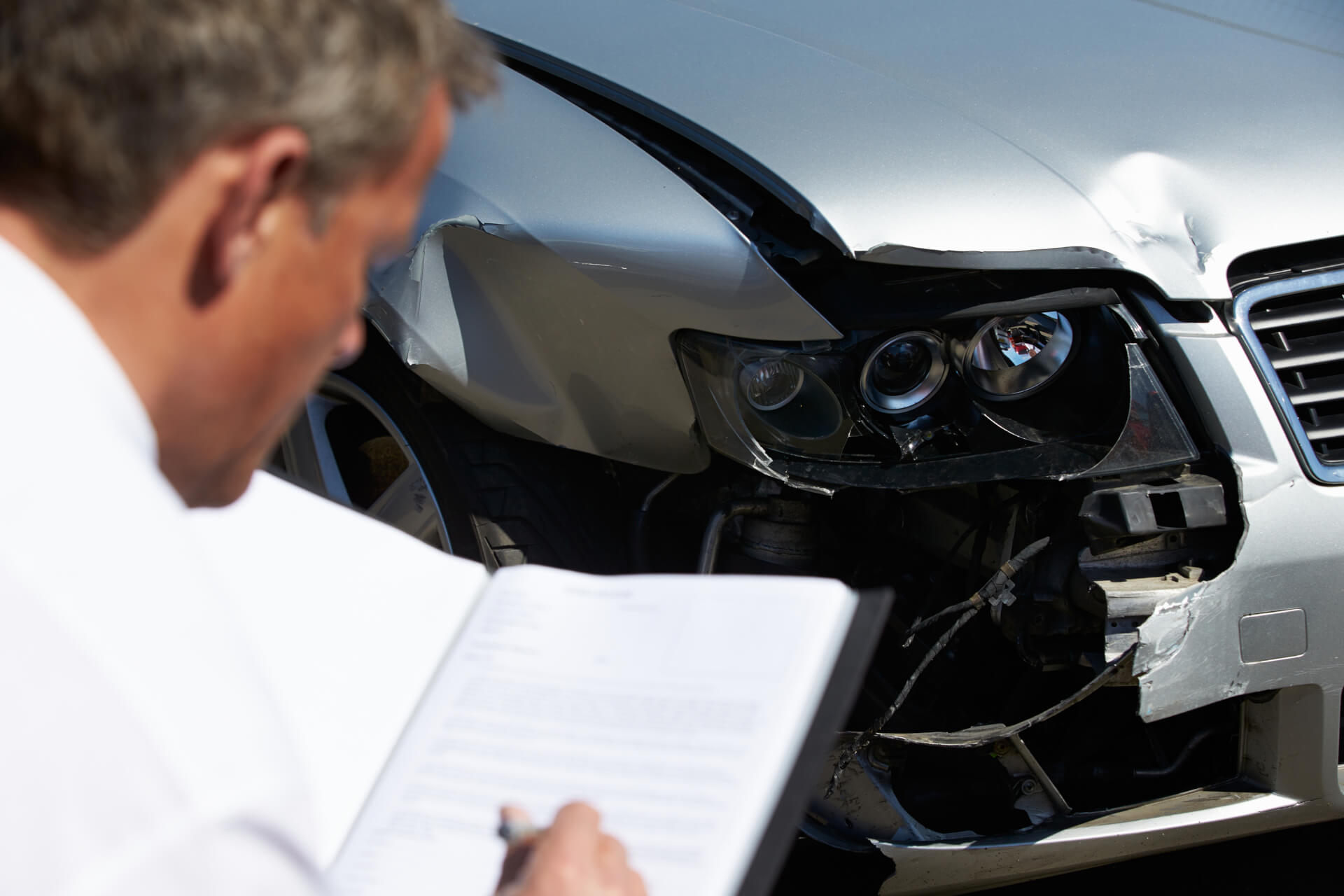 Insurance Adjuster inspecting vehicle